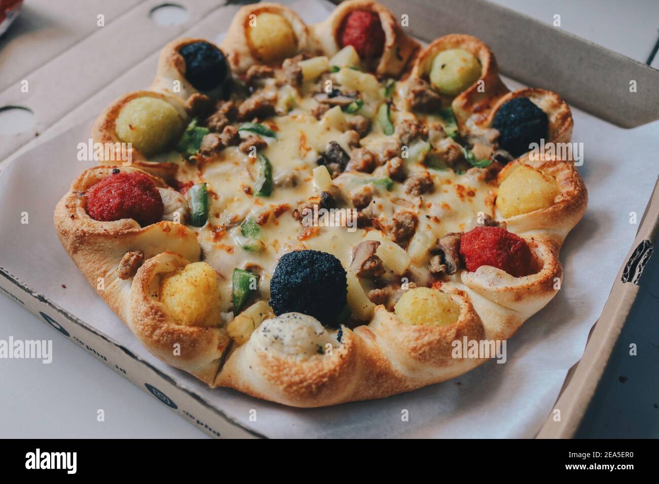 Mozzarella cheese Pizza in opened from the box with Colourful crust on