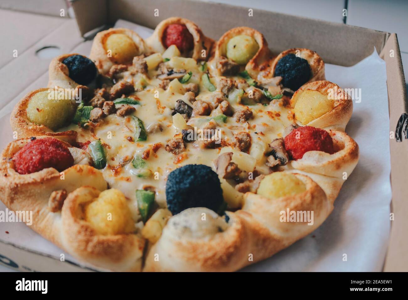 Mozzarella cheese Pizza in opened from the box with Colourful crust on