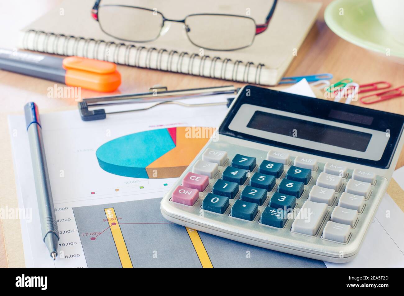 Data Graphing Calculator, pen, glasses and a cup of coffee and put on your desk. Stock Photo