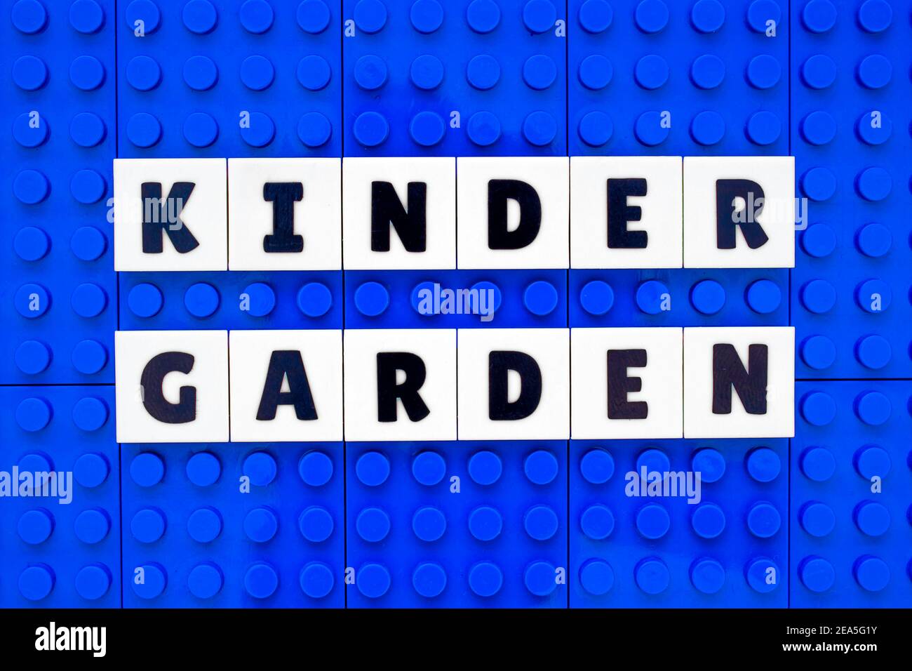 Kinder Garden sign text build with interlocking plastic white and blue bricks Stock Photo
