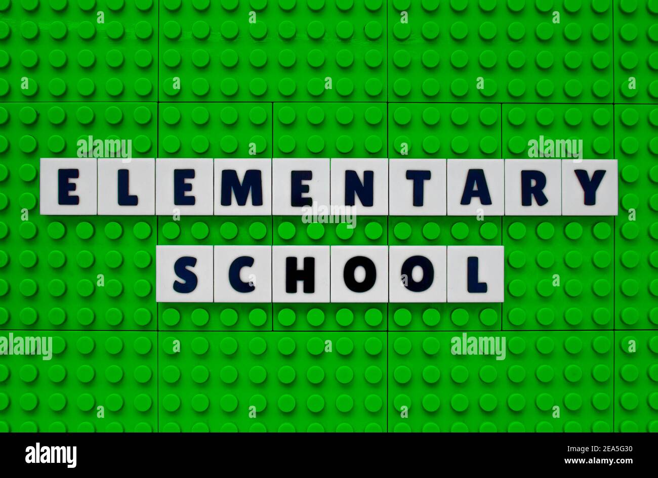 Elementary School sign text build with interlocking plastic white and sky green bricks Stock Photo