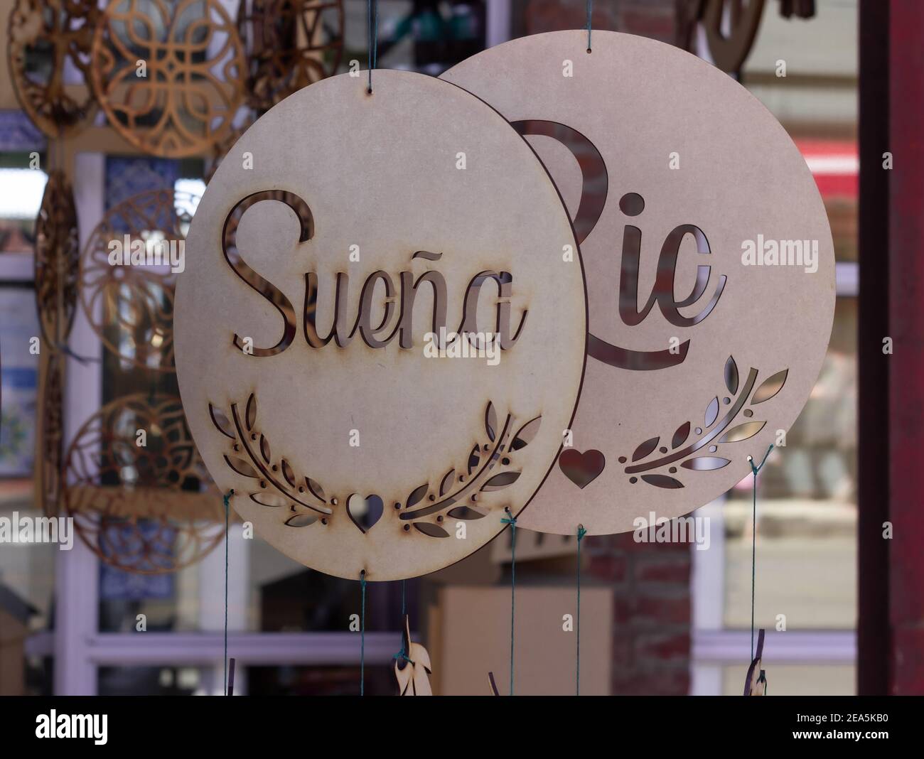 Wooden hanging crafts with the spanish words 'Dream' and 'Laugh'. Stock Photo