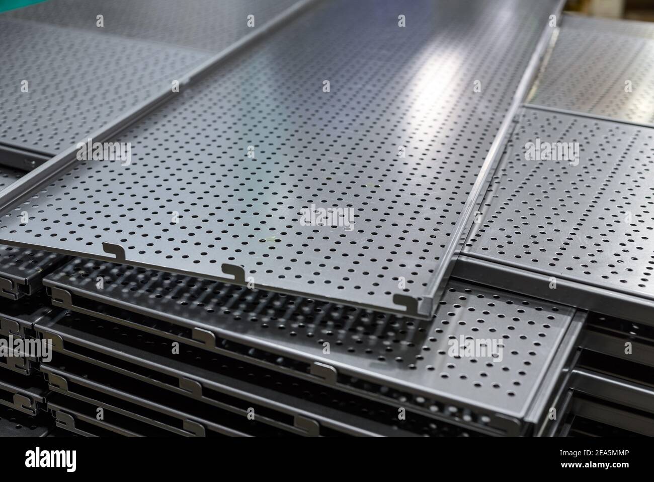Metal shelves for storage racks. Products of the plant for the production of metal profiles, products stacked. Stock Photo