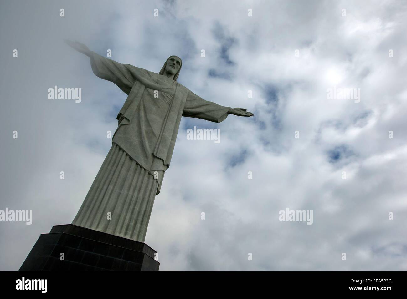 The statue of Christ the Redeemer at Rio de Janeiro in Brazil. The statue which is 30 metres high, sits atop Corcovado Mountain. Stock Photo