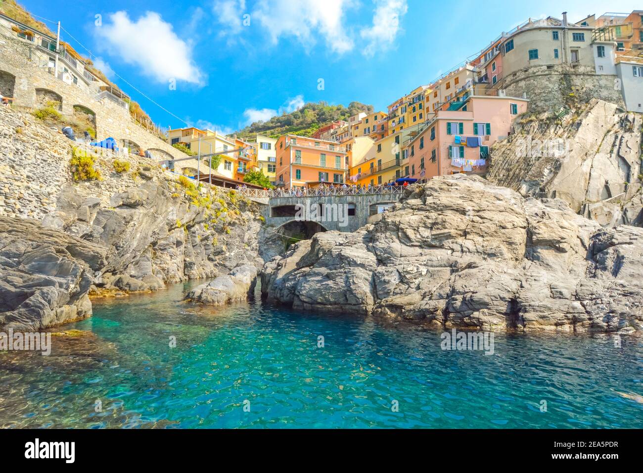 The rocky coastline and swimming bay on the Ligurian Coast of Italy at the village of Manarola, Italy, part of the Cinque Terre, an Unesco site Stock Photo