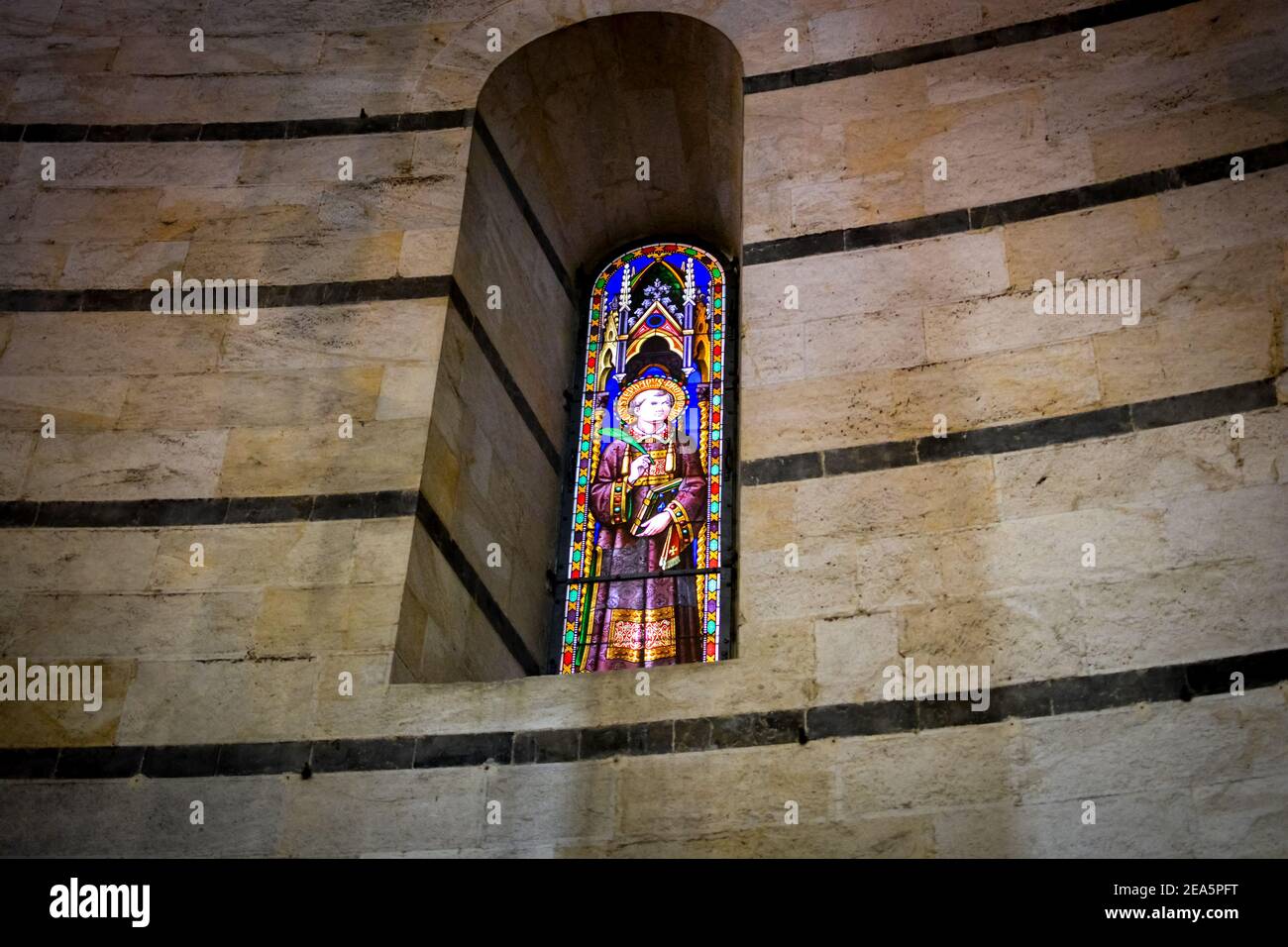 Stained glass windows depicting Saint Bernard in the medieval Baptistery of St. John on the historic Piazza dei Miracoli of Pisa, Italy Stock Photo