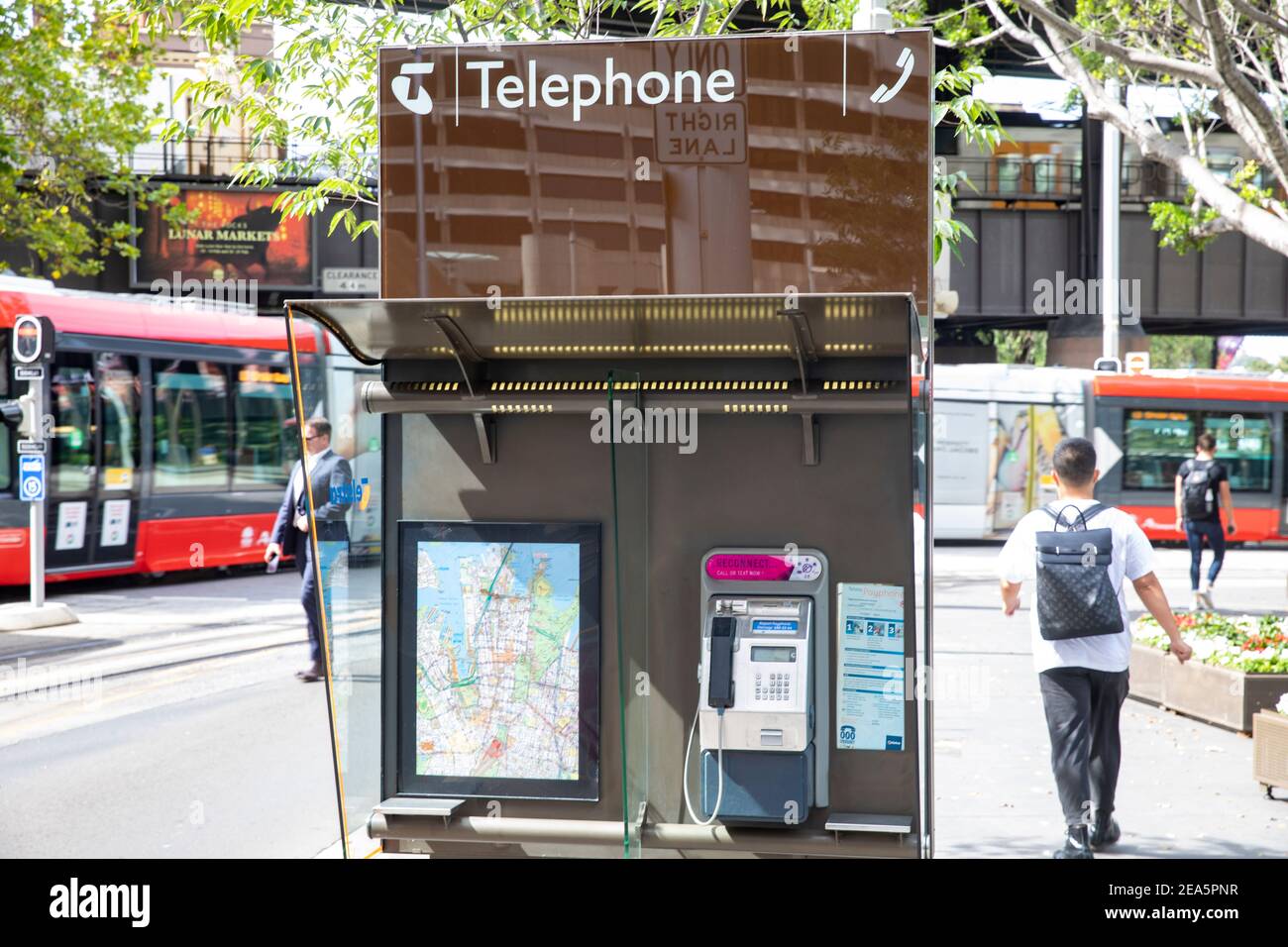 Traditional Telstra public phone booth payphone using landline technology,Sydney city centre,NSW,Australia Stock Photo