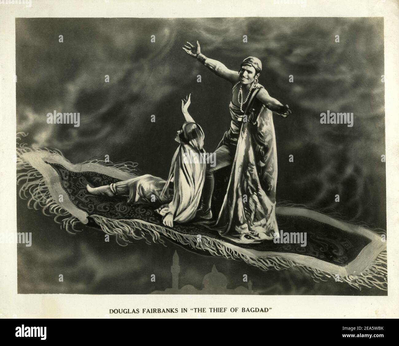 Artwork promotional Still of JULANNE JOHNSTON and DOUGLAS FAIRBANKS Sr on Flying Carpet in THE THIEF OF BAGDAD 1924 director RAOUL WALSH story Douglas Fairbanks (as Elton Thomas) production design / art direction William Cameron Menzies costume design Mitchell Leisen Douglas Fairbanks Pictures / United Artists Stock Photo