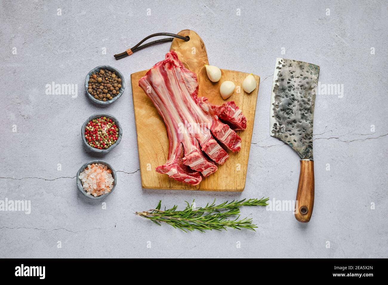 Overhead view of raw fresh deer ribs with spice and herb over concrete ...
