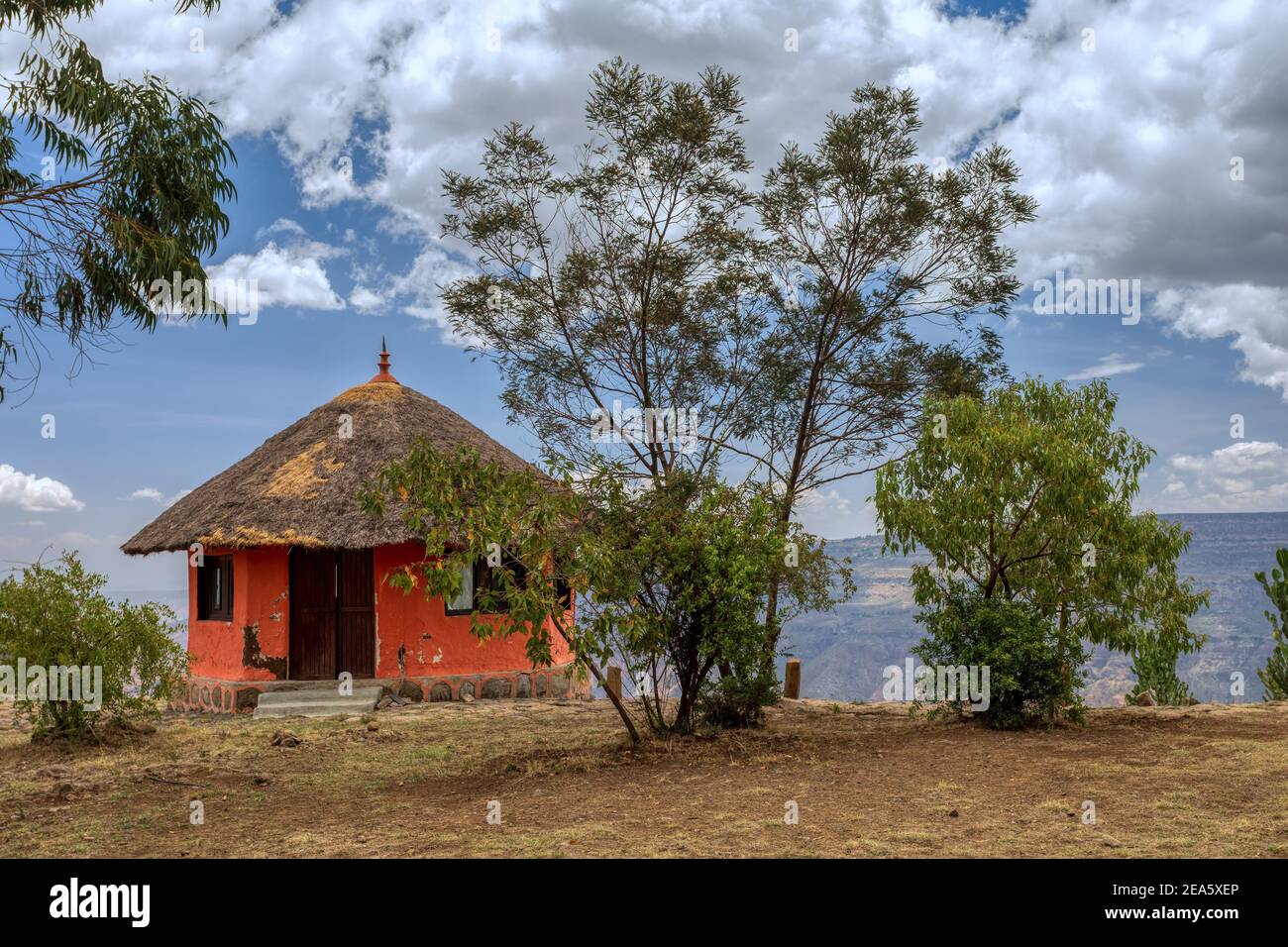 Beautiful colored traditional ethiopian house situated in mountain landscape with scenic view to