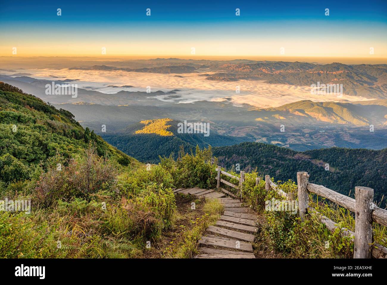 Tropical forest nature landscape view with toursits mountain range and moving cloud mist at Kew Mae Pan nature trail, Doi Inthanon, Chiang Mai Thailan Stock Photo