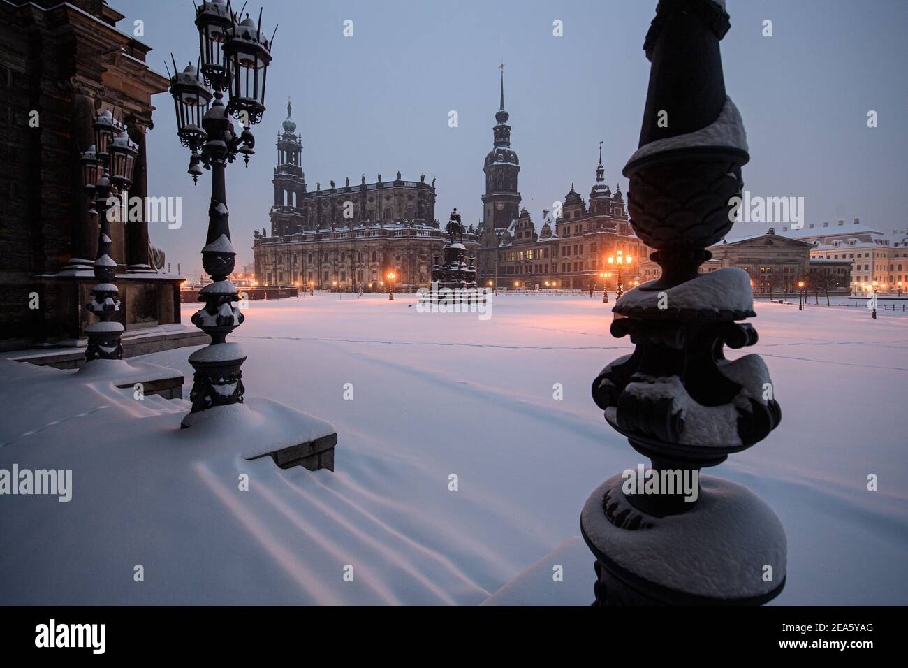 Dresden, Germany. 08th Feb, 2021. Snow-covered is the Theaterplatz in front of the Semperoper (l-r), the Hofkirche, the equestrian statue of King Johann, the Hausmannsturm, the Residenzschloss and the Schinkelwache in the morning. Credit: Robert Michael/dpa-Zentralbild/dpa/Alamy Live News Stock Photo