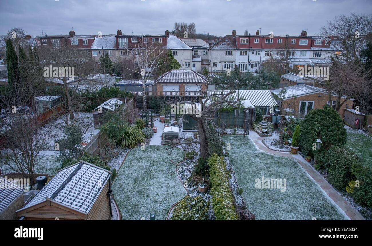 London, UK. 8 February 2021. In the aftermath of Storm Darcy, a light covering of snow on the ground in south west London with icy suburban side roads and daytime temperatures due to remain below zero under grey sky. Credit: Malcolm Park/Alamy Live News. Stock Photo