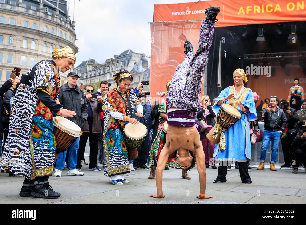 African performance with acrobatic street dance, drumming and dance group in colourful costumes at 'Africa on the Square', Trafalgar Square, London Stock Photo