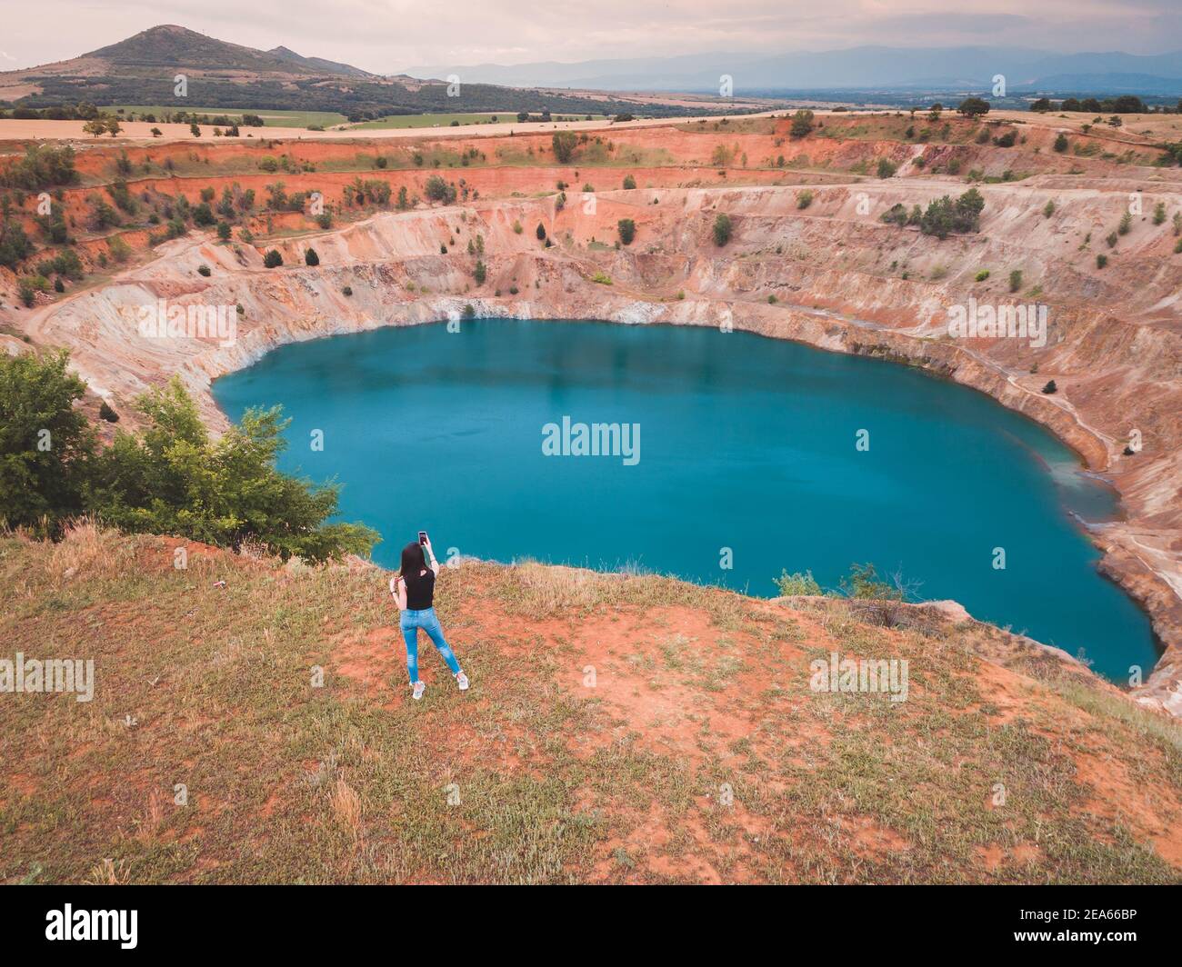 Aerial view of woman photographer doing selfie in font of copper mine Stock Photo