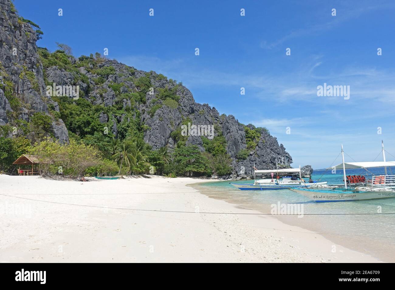 Pristine white beach with coconut palm trees in the Philippines Stock Photo