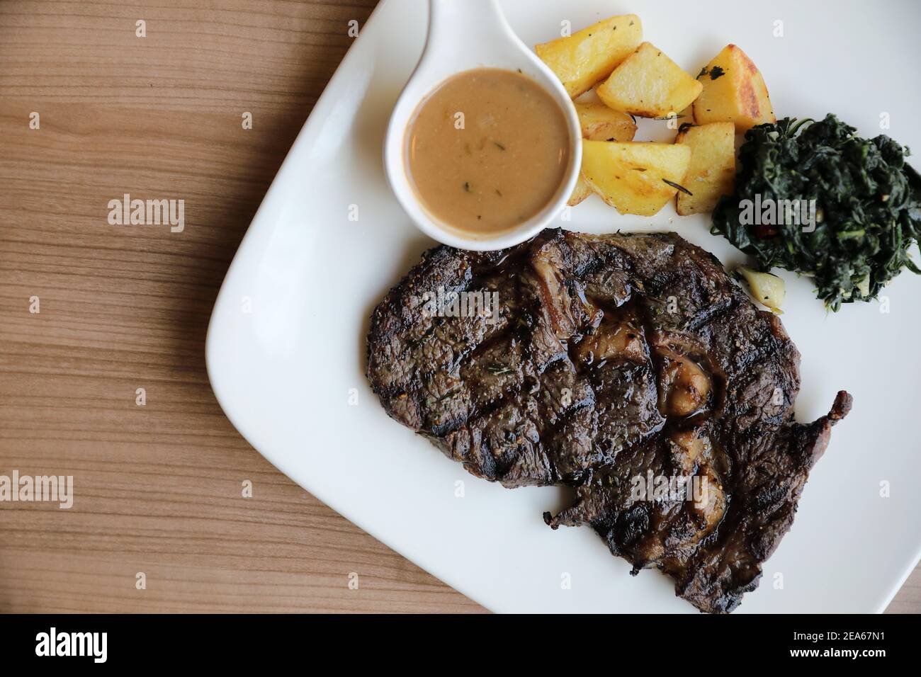 beef steak with potato on wood background Stock Photo - Alamy