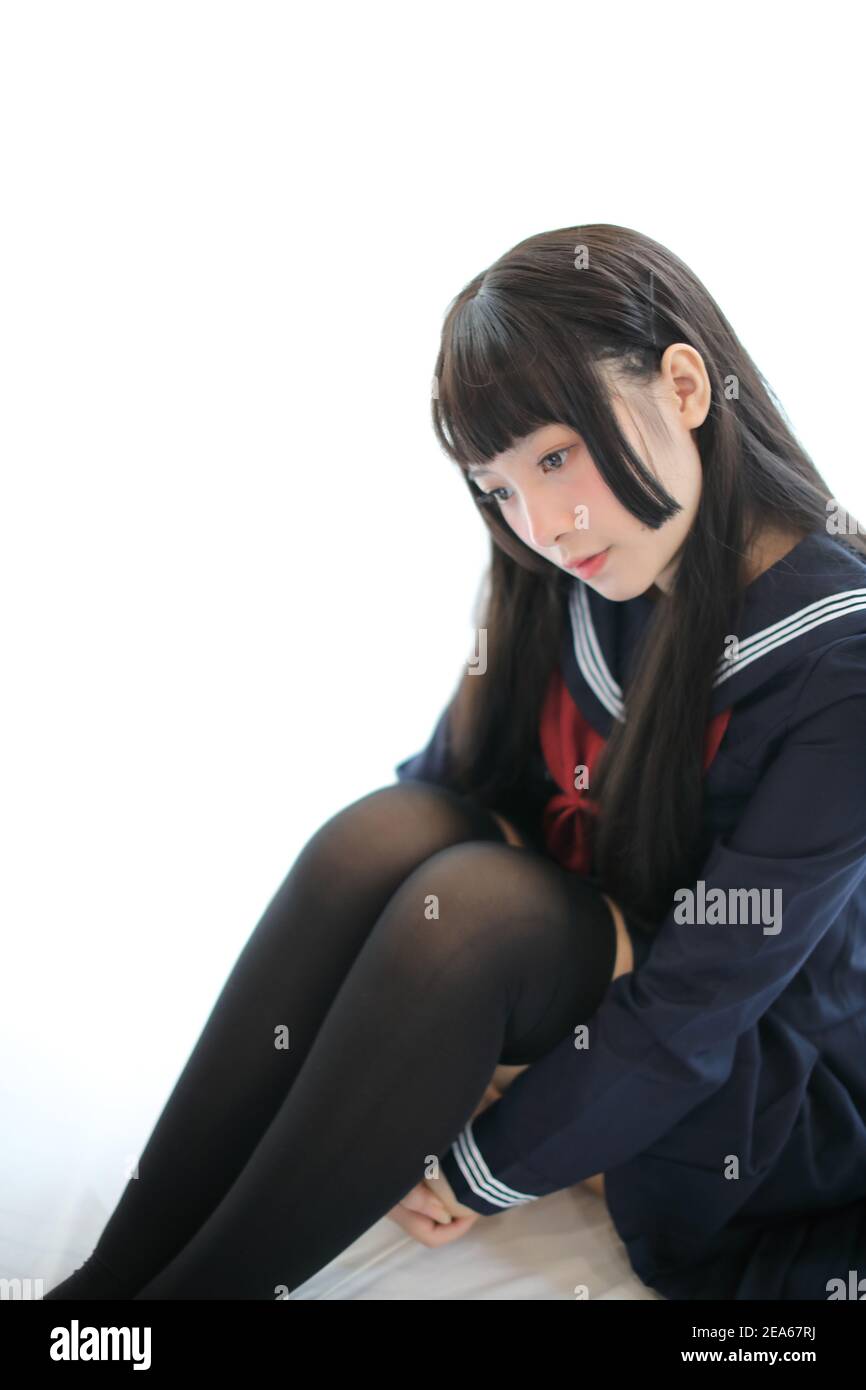 Portrait japanese school girl in white tone bed room Stock Photo