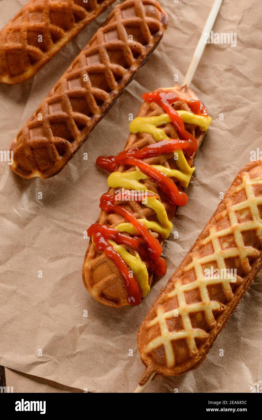 Waffle corn dogs with mustard and ketchup splashes Stock Photo - Alamy