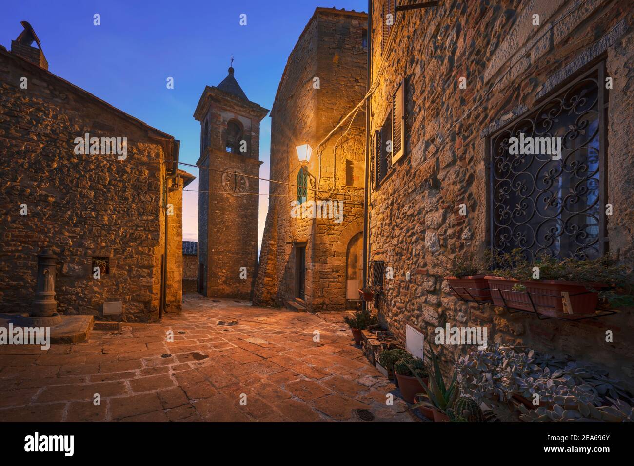 Casale Marittimo old village in Maremma at sunset. Picturesque flowery square and campanile tower. Tuscany, Italy Europe. Stock Photo