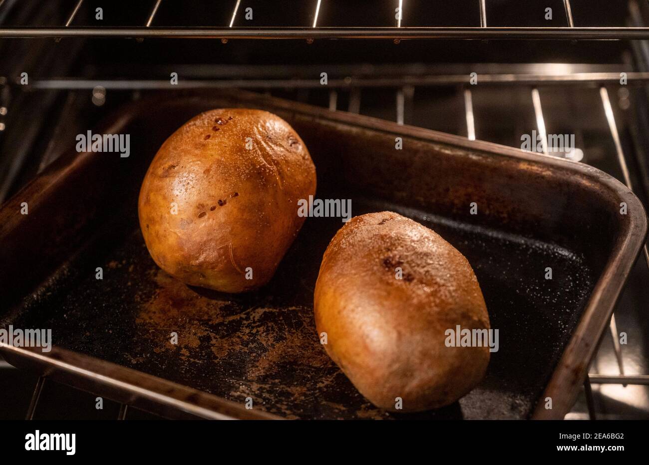 Baking potatoes in their skins or jackets in electric oven on a tray