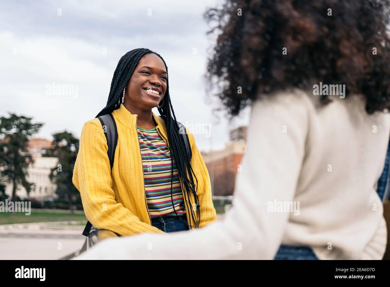 Stock photo of black students talking and laughing in the street. Stock Photo