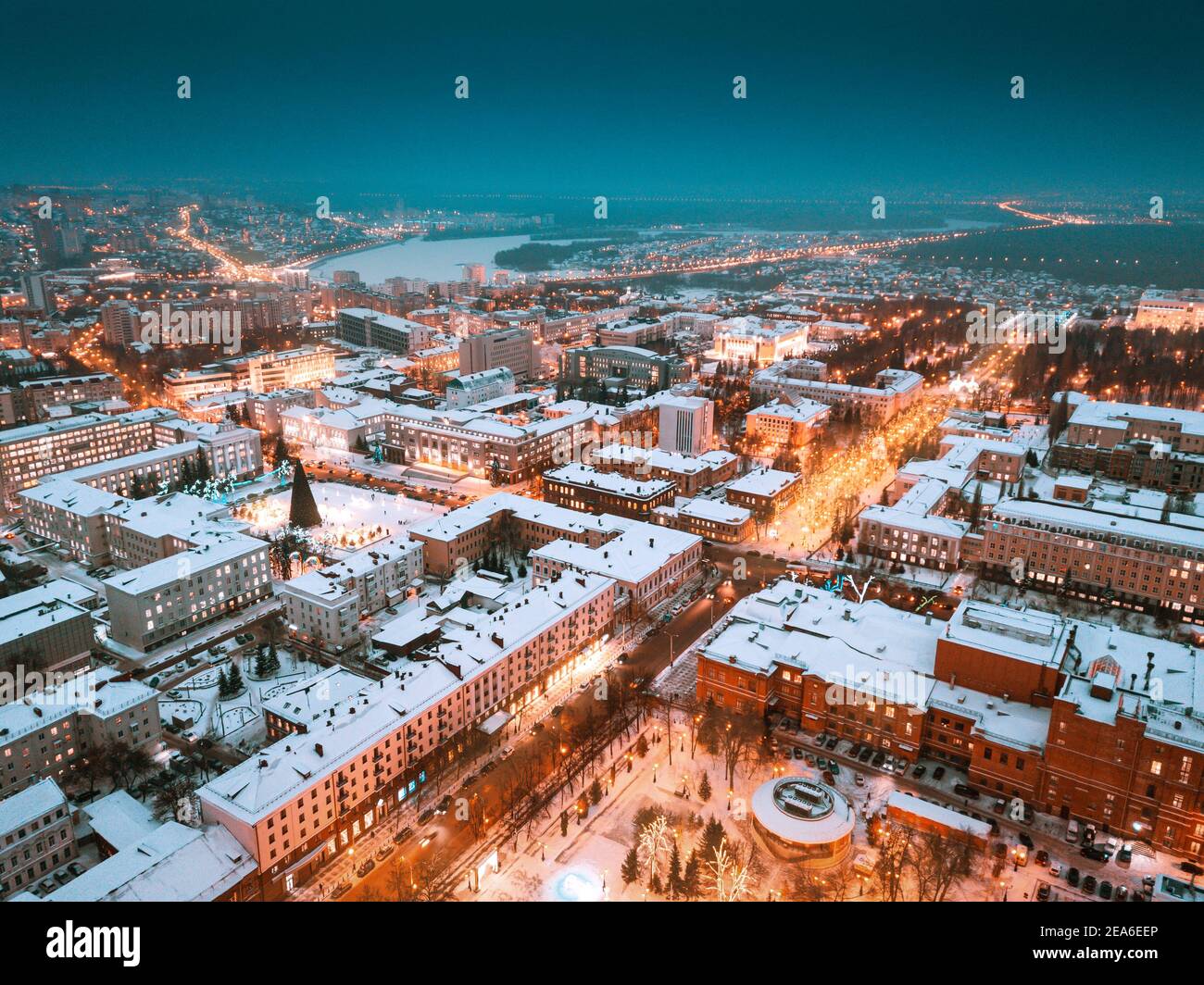 Aerial drone view of an evening city in winter with streets and ...