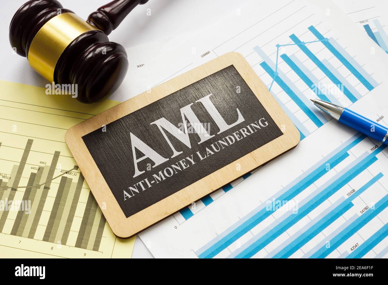 AML anti-money laundering plate and gavel with papers. Stock Photo