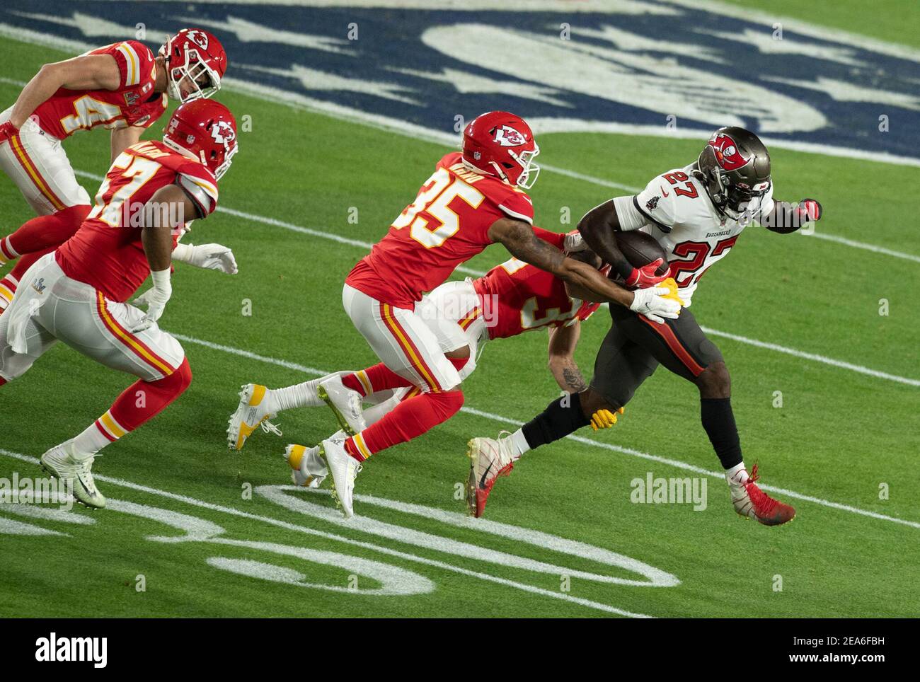 Tampa. 8th Feb, 2021. Ronald Jones (1st R) of Tampa Bay Buccaneers breaks thorugh during the NFL Super Bowl LV football game between Tampa Bay Buccaneers and Kansas City Chiefs in Tampa, Florida, the United States, Feb. 7, 2021. Credit: Xinhua/Alamy Live News Stock Photo