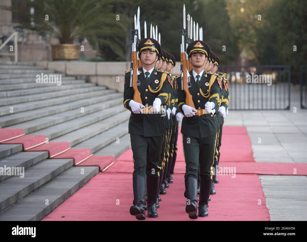 Chinese soldiers of the presidential honour guard holding rifles and weapons march in tight formation during a foreign dignity visit to the capital city of China, at the Great Hall of the People in Tiananmen Square in central Beijing © Time-Snaps Stock Photo