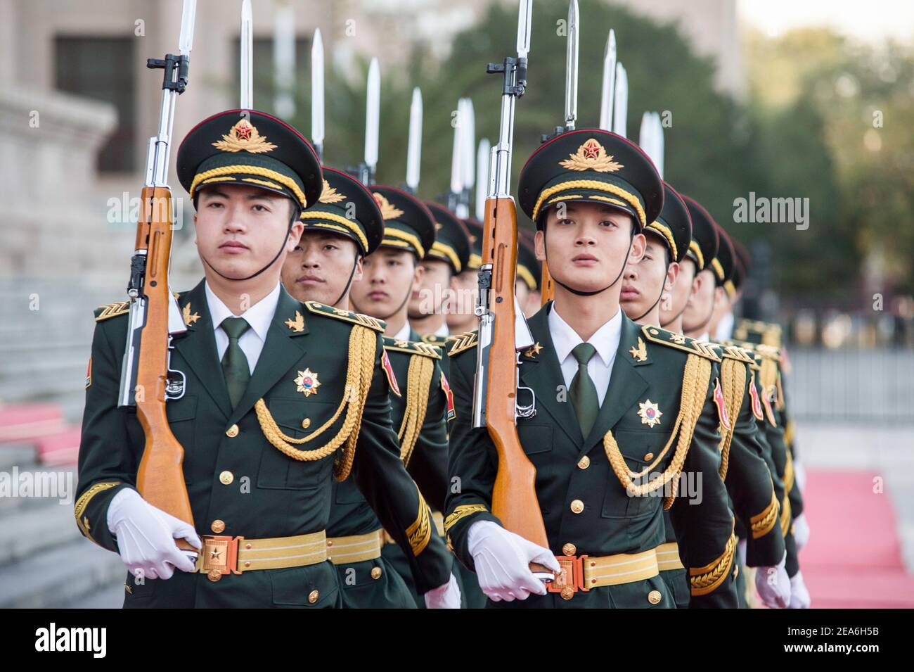 Chinese soldiers of the presidential honour guard holding rifles and weapons march in tight formation during a foreign dignity visit to the capital city of China, at the Great Hall of the People in Tiananmen Square in central Beijing © Time-Snaps Stock Photo