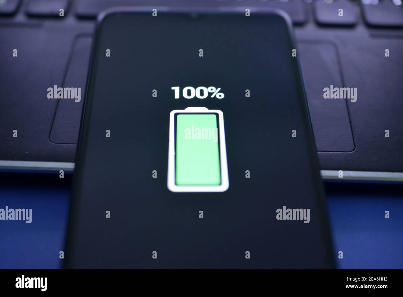 Closeup view of smartphone charging , battery level at full capacity