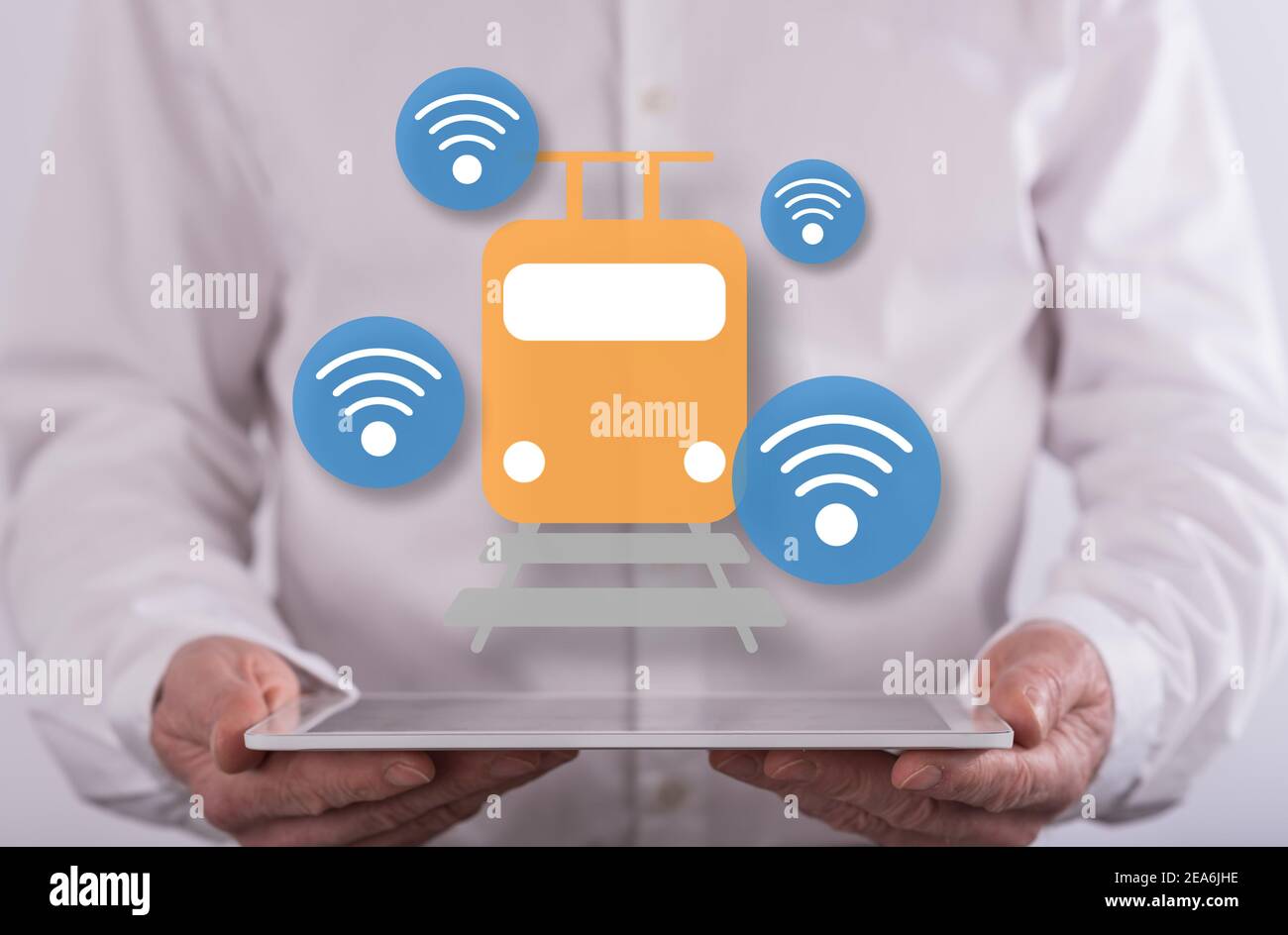 Smart train concept above a tablet held by a man in background Stock Photo