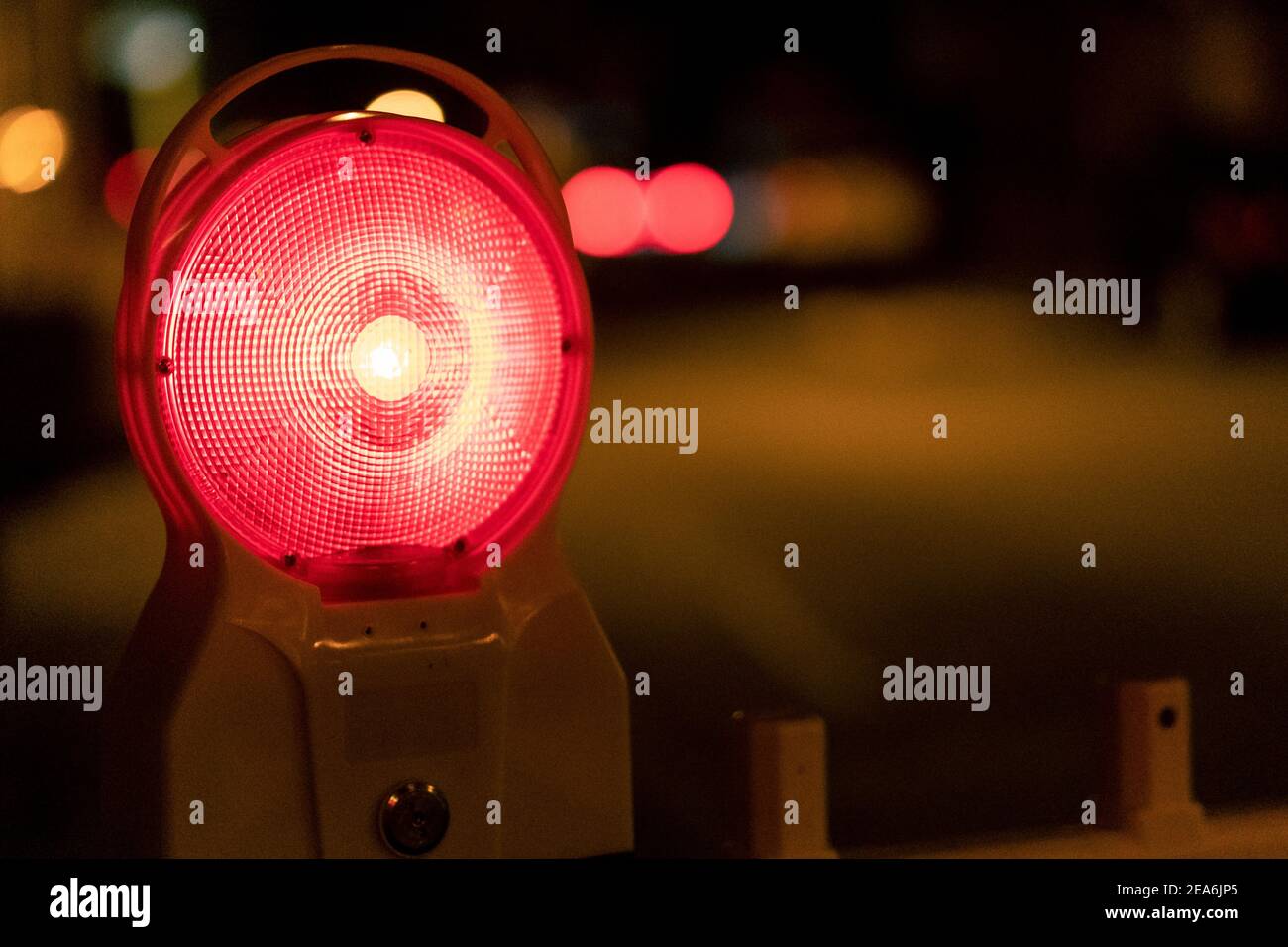 Selective focus shot of the red warning lamp burning at night Stock