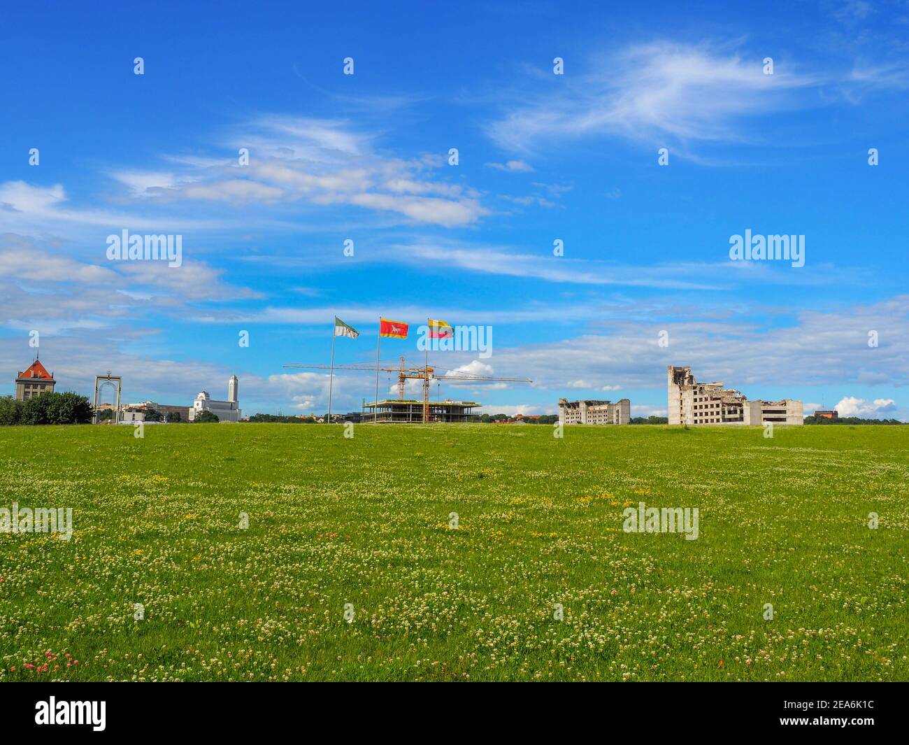 Landscape of Kaunas visible from Nemunas island near Žalgiris arena. Clover meadow, ruins of old buildings and construction of a new business center. Stock Photo