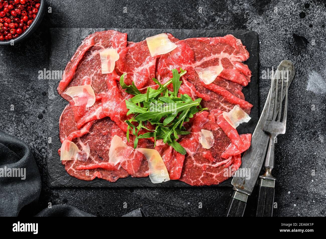 Italian Beef carpaccio with arugula salad, parmesan cheese. Black