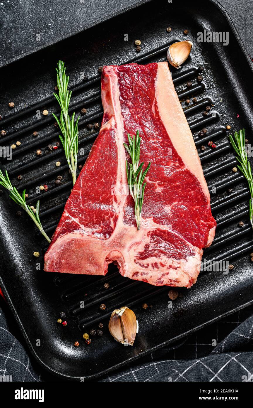 Porterhouse raw steak. Organic meat beef. Black background. Top view ...