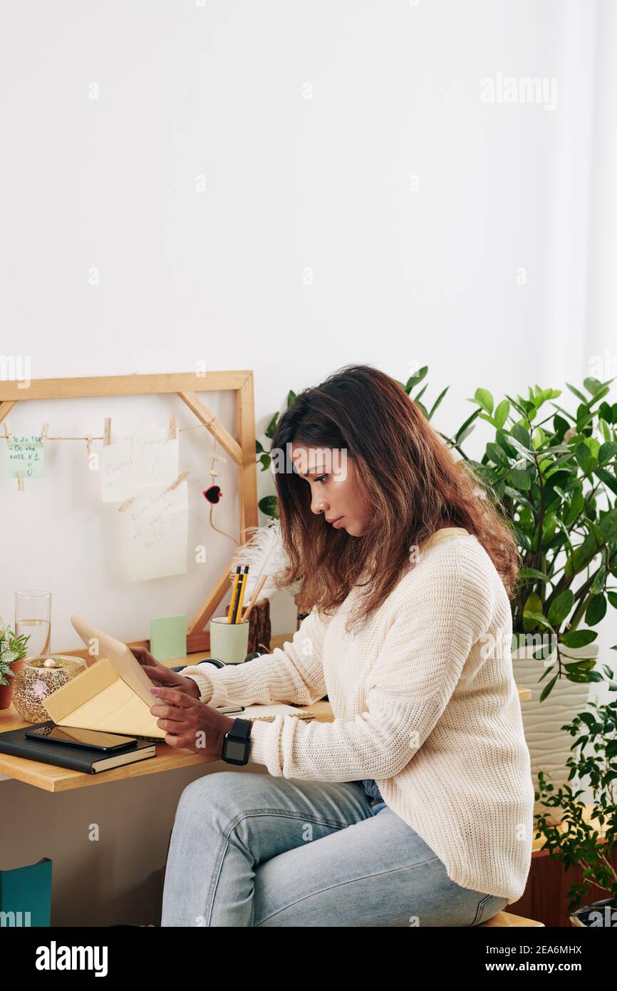 Woman checking e-mails from clients Stock Photo