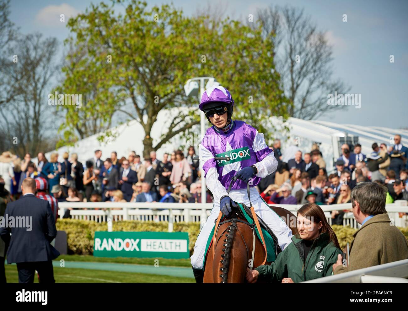 Jockeys at The Grand National making their way around the parade ring