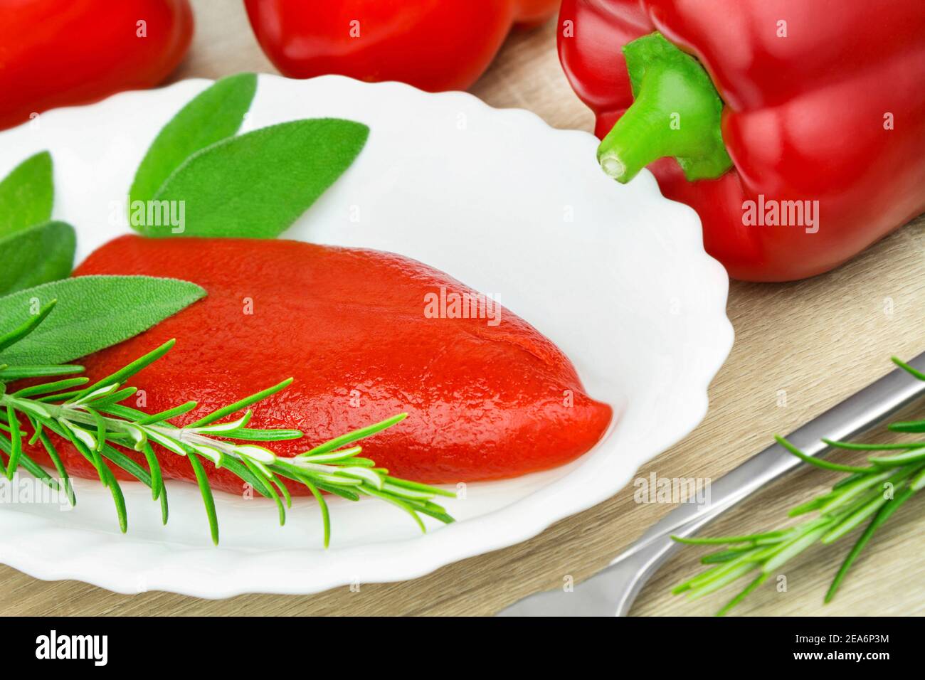 Red paprika and fresh herbs close up Stock Photo