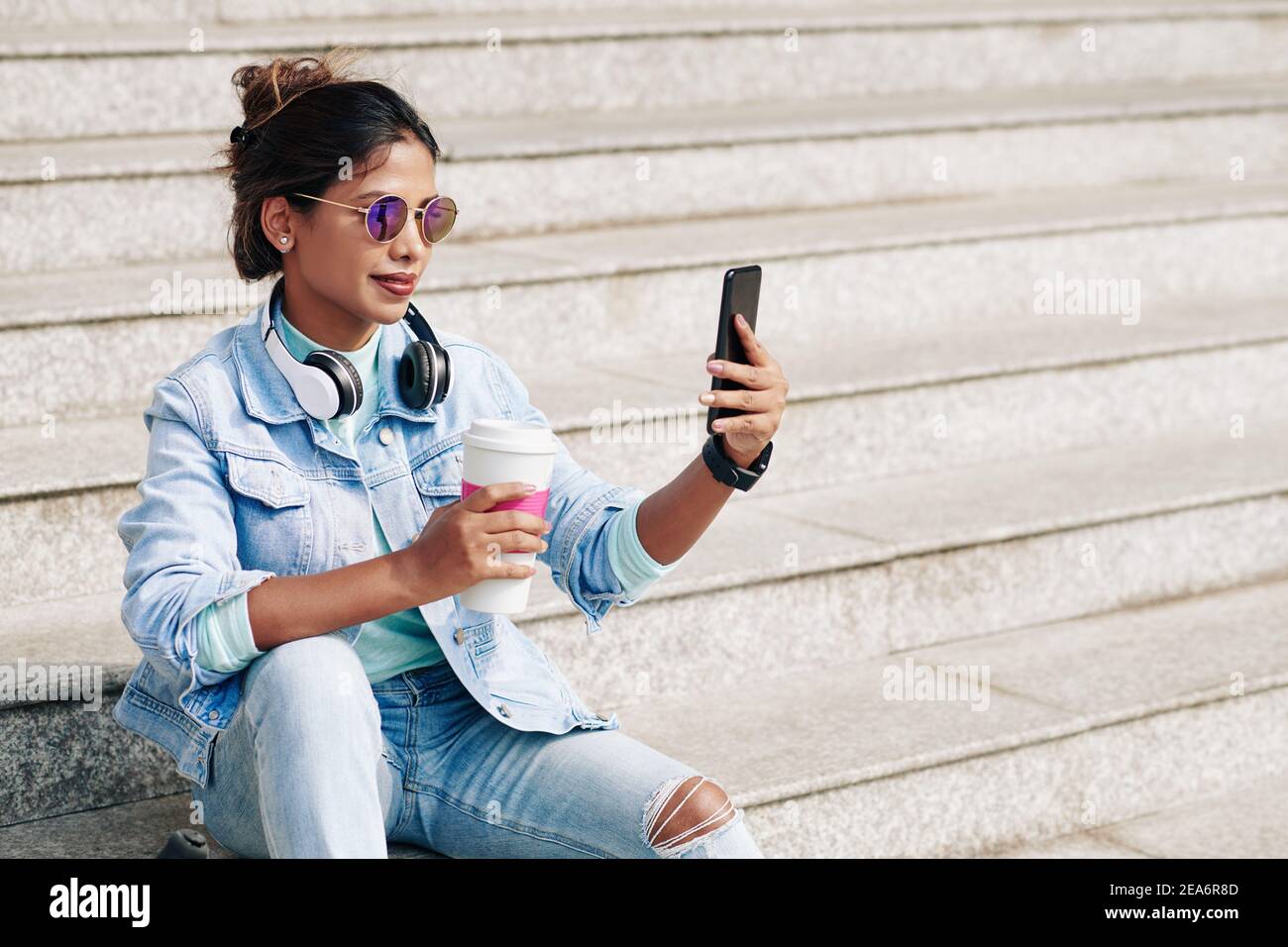 Woman taking selfie with coffee cup Stock Photo - Alamy
