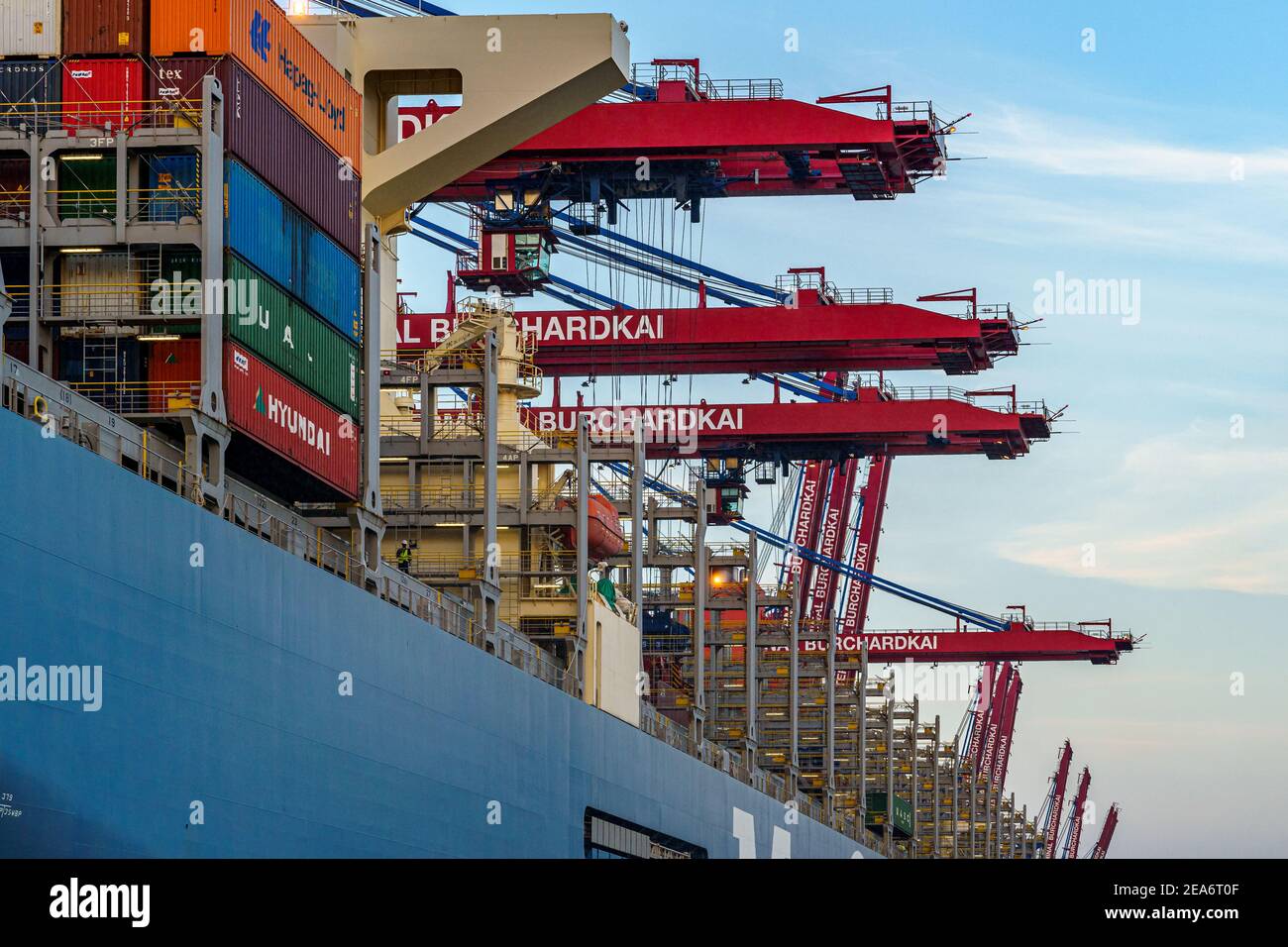HAMBURG, GERMANY - Aug 08, 2020: Closeup view to the deck of a big container ship. Also see some cranes loading the ship Stock Photo