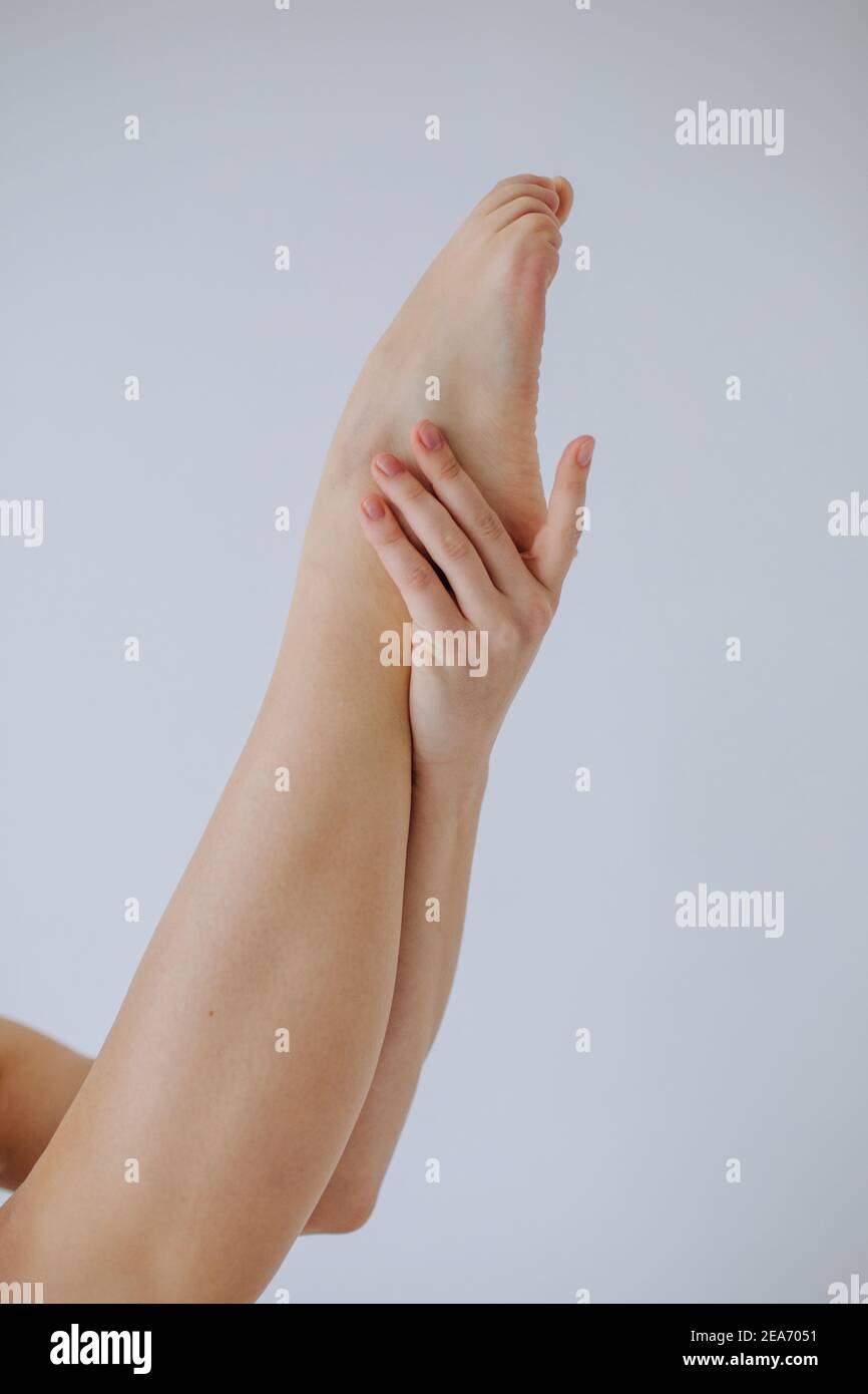 Close-up of a woman holding her leg in the air Stock Photo
