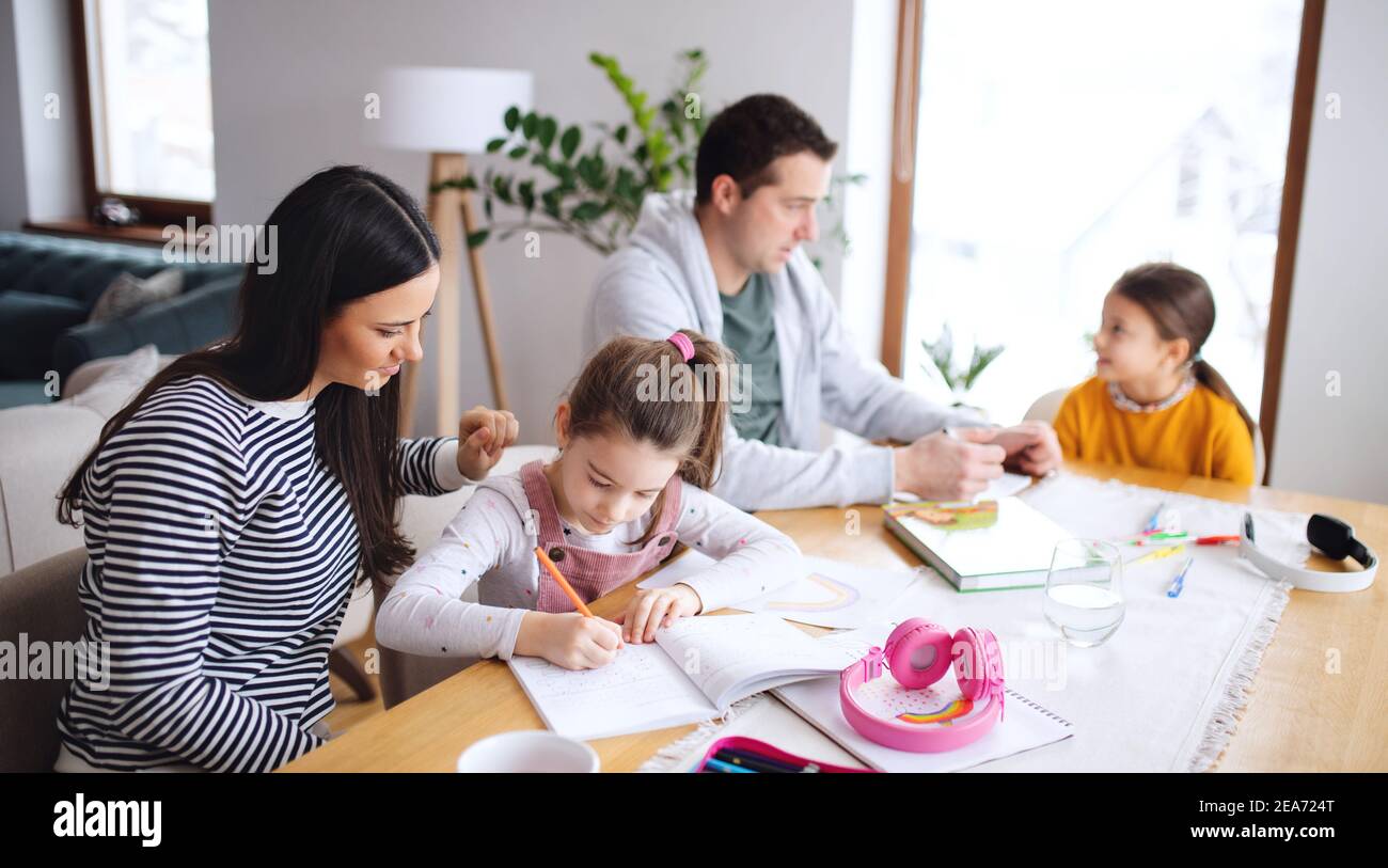 Parents with school girls indoors at home, distance learning Stock ...