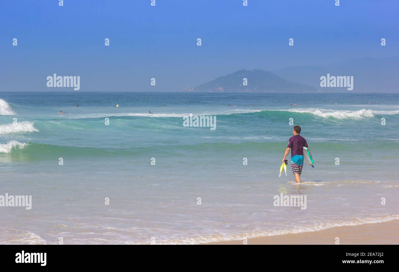 Surfer holding surfboard entering hi-res stock photography and images ...