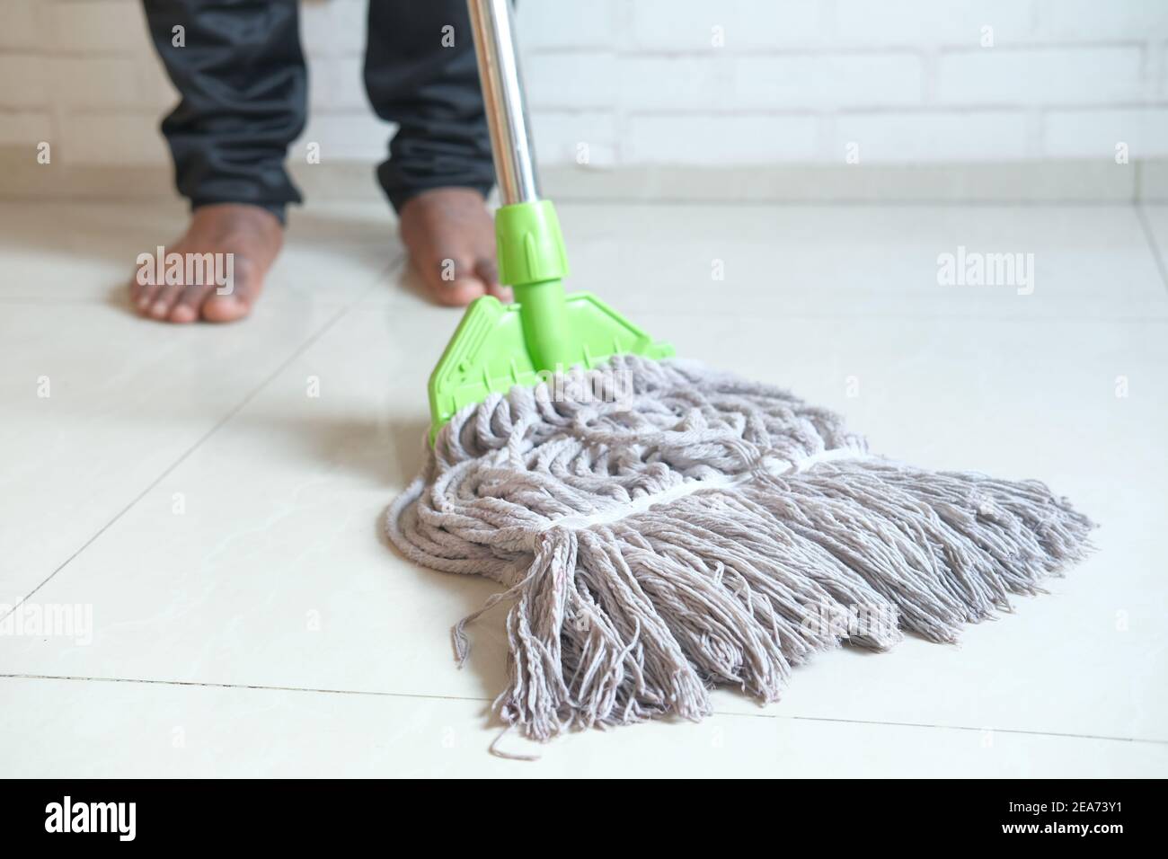 cleaning tiles floor with mop Stock Photo Alamy