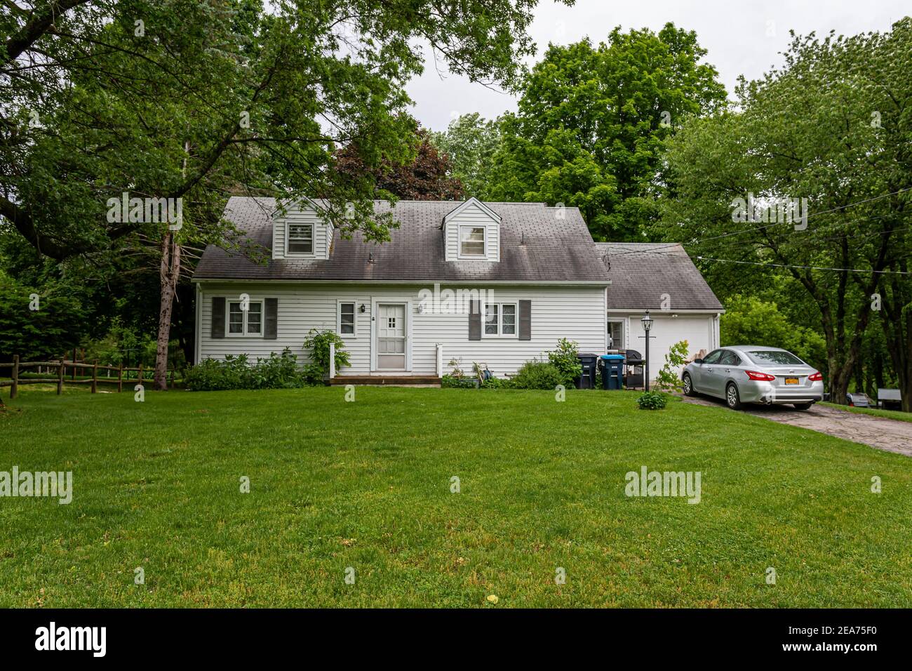 Penfield, New York, USA June 14, 2019 typical American residential house building with green
