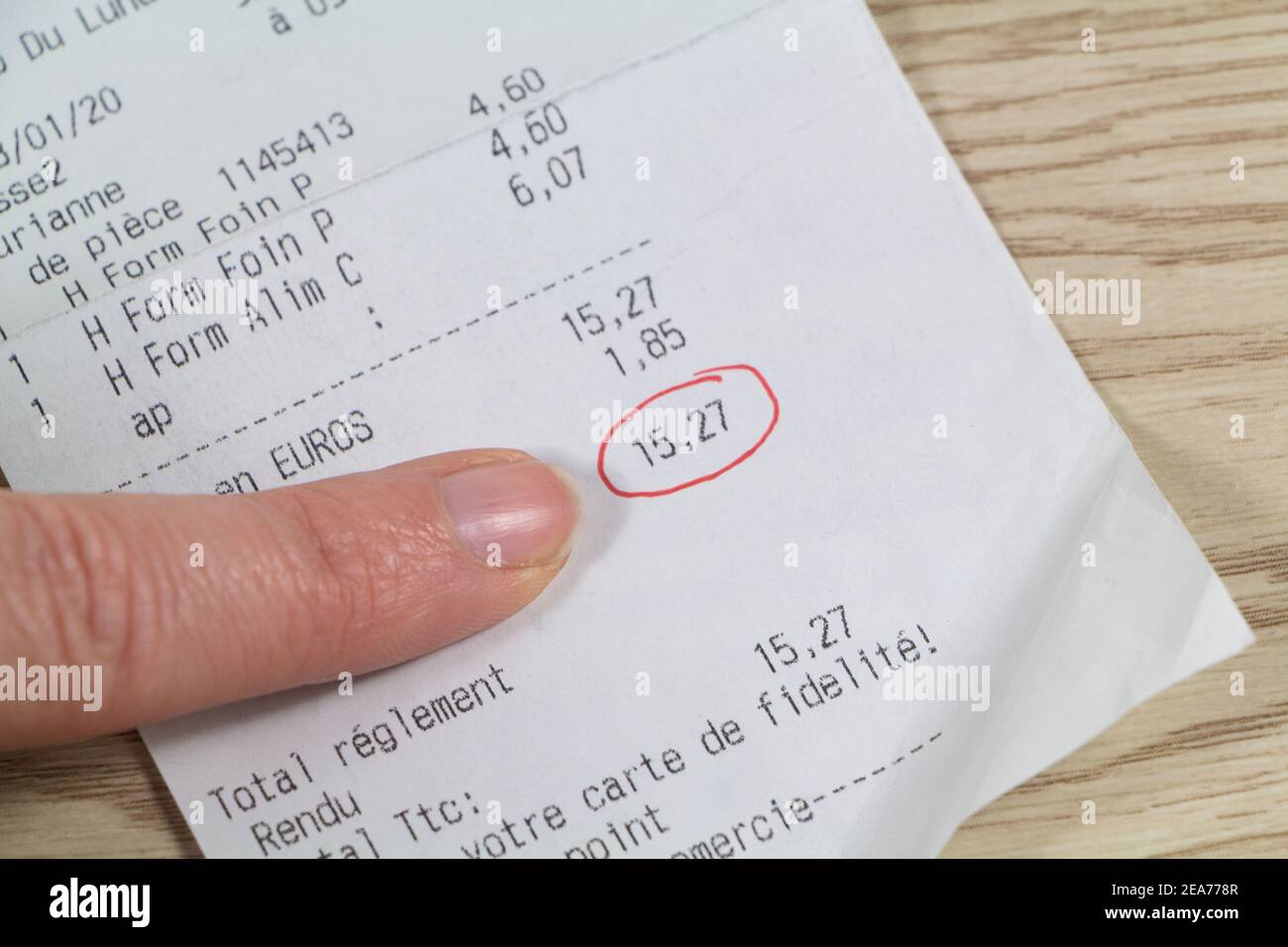 Receipt of a pet shop with hay food, fidelity card written in french language and total surrounded in red Stock Photo