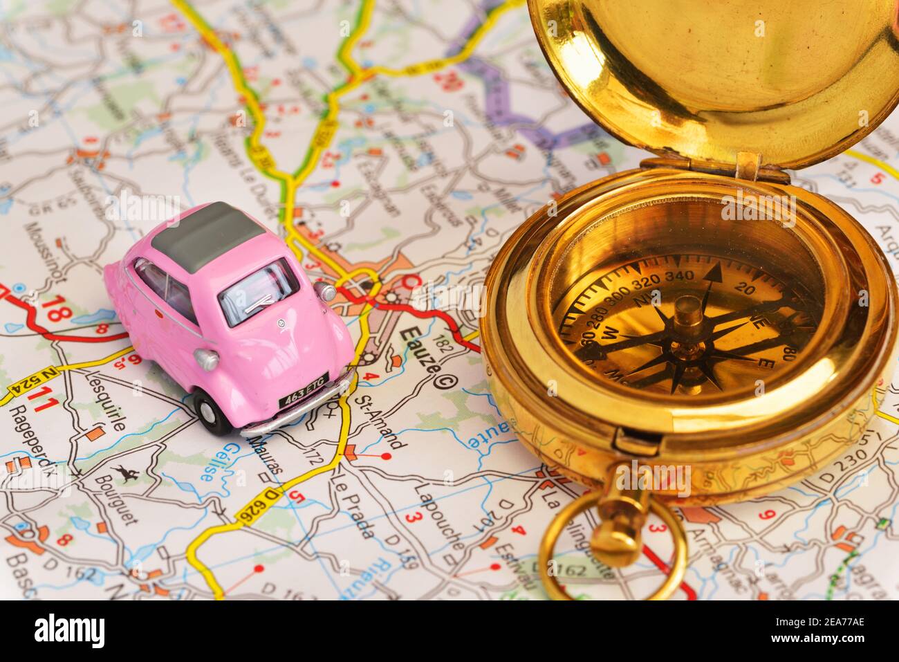 Toy 1950's pink BMW Isetta bubble car and a compass on map of France showing part of the Armagnac producing region Stock Photo