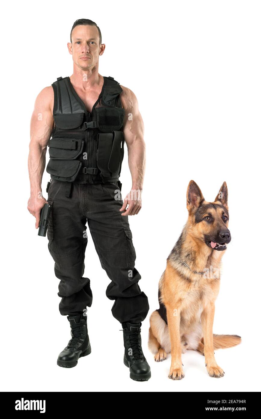 Police dog and agent with tactical vest and gun isolated in white Stock Photo